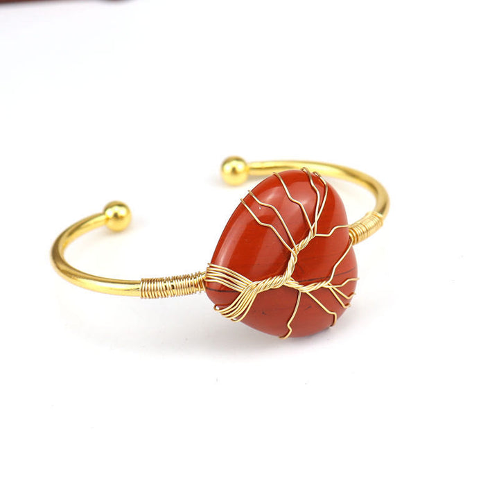 Pulsera de cristal natural en forma de corazón envuelta en alambre de cobre y oro de Olivenorma.