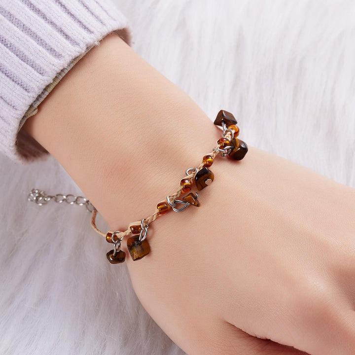 Pulsera trenzada con borlas de obsidiana, ojo de tigre y amatista de Olivenorma