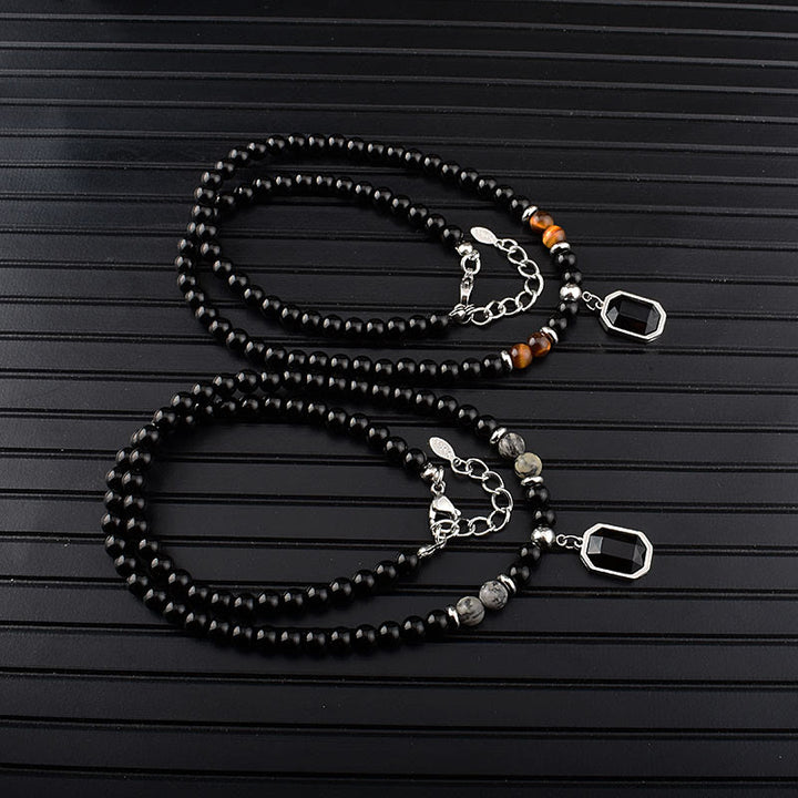 Collar de acero y titanio con cuentas de obsidiana y ojo de tigre para hombre de Olivenorma