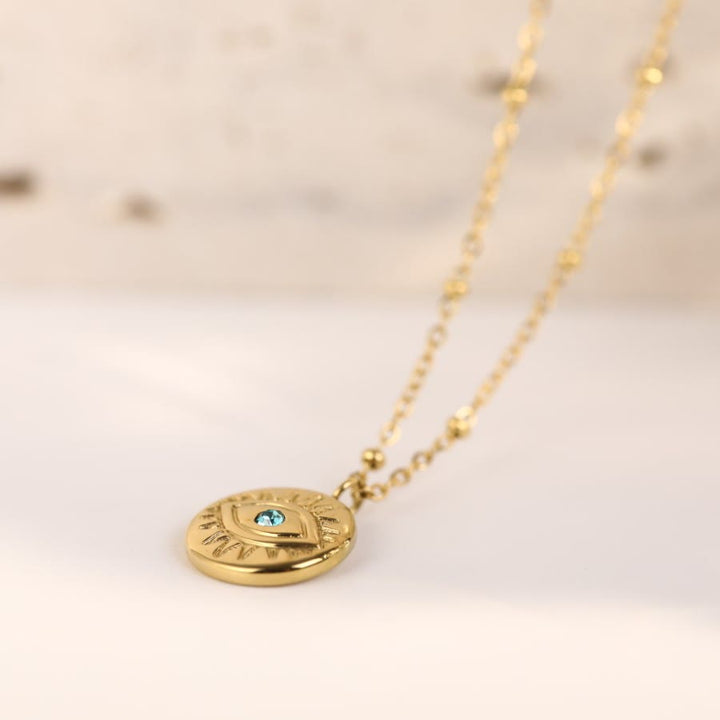 Collar de acero de titanio 316L con ojo malvado y topacio azul de Olivenorma