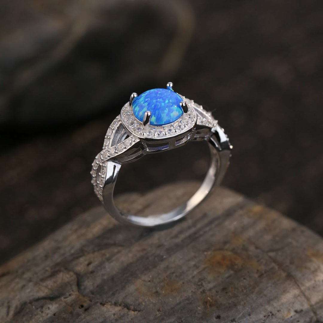 Anillo de plata de ley 925 con circonita blanca y ópalo azul de Olivenorma