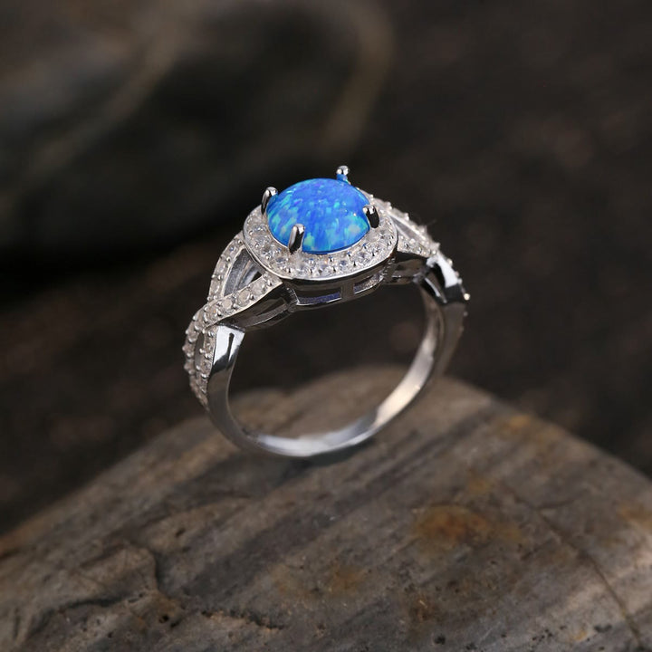 Anillo de plata de ley 925 con circonita blanca y ópalo azul de Olivenorma