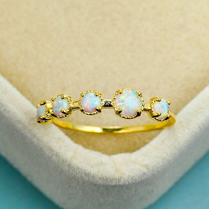 Anillo de diseño sencillo con cinco ópalos blancos y azules de Olivenorma