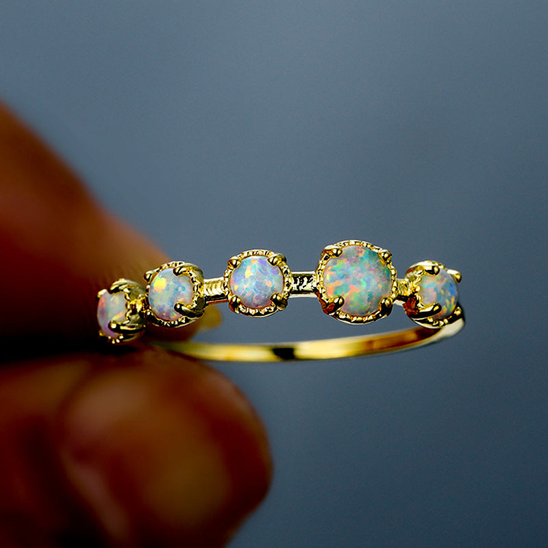 Anillo de diseño sencillo con cinco ópalos blancos y azules de Olivenorma