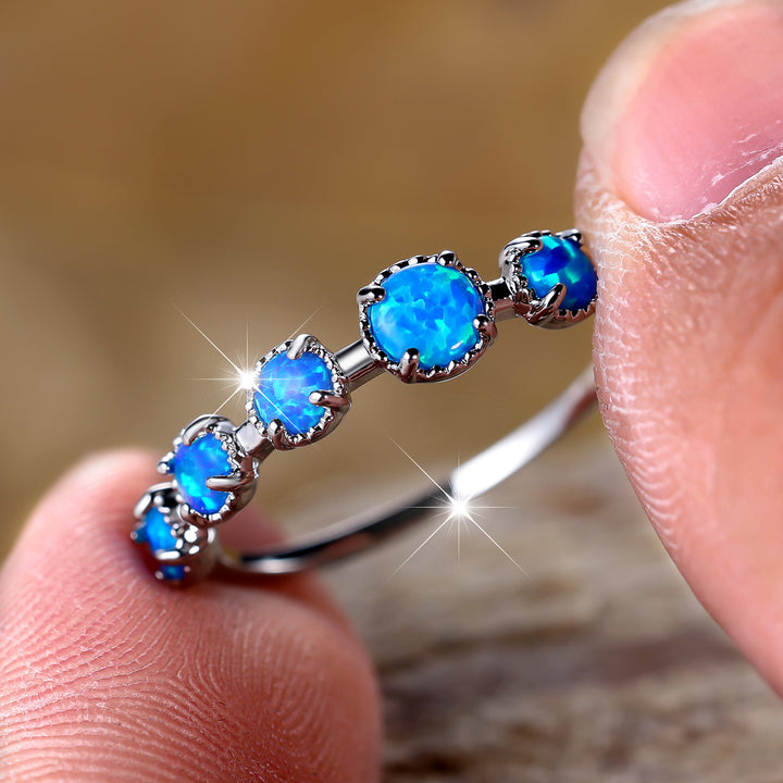 Anillo de diseño sencillo con cinco ópalos blancos y azules de Olivenorma