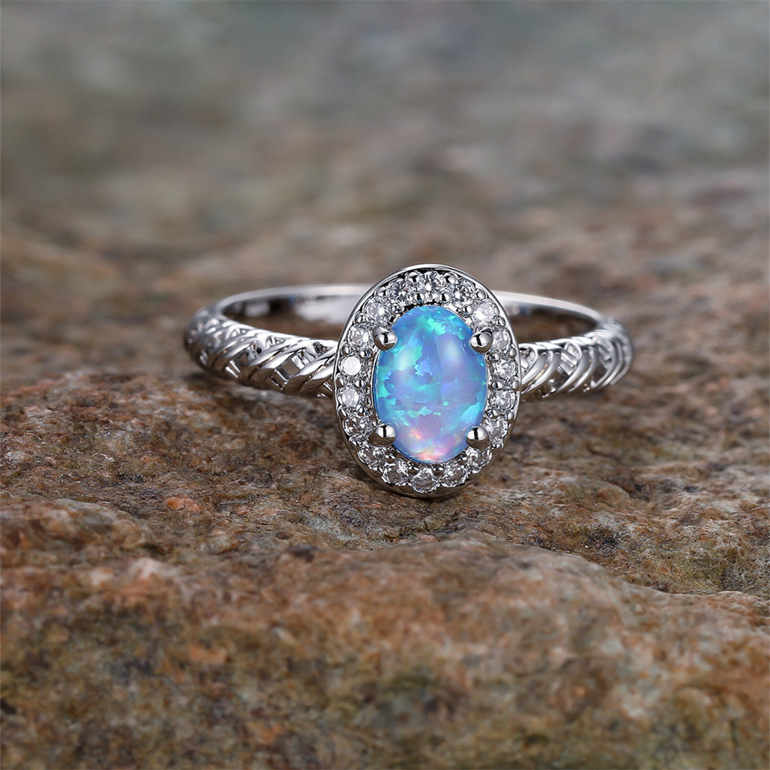 Anillo con diseño de cuerda trenzada con borde de ópalo ovalado de Olivenorma
