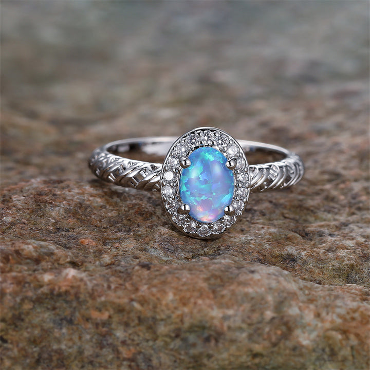 Anillo con diseño de cuerda trenzada con borde de ópalo ovalado de Olivenorma