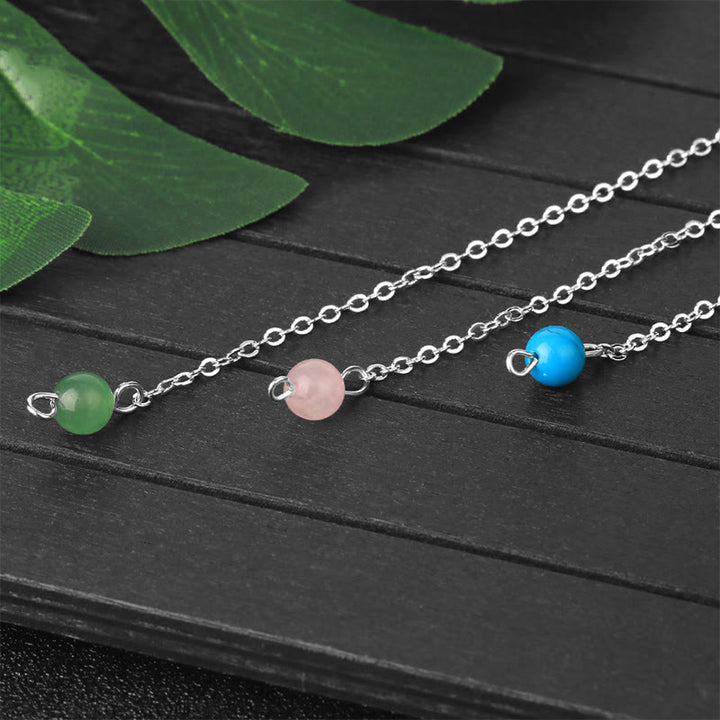Péndulo facetado con piedra preciosa natural con símbolo OM de Olivenorma