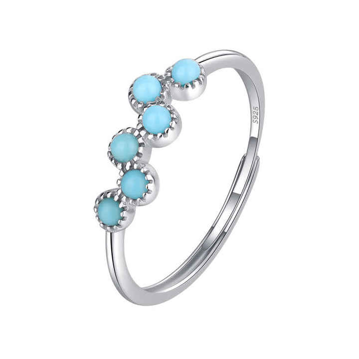 Anillo de pareja creativo de cuatro garras con turquesa redonda de Olivenorma