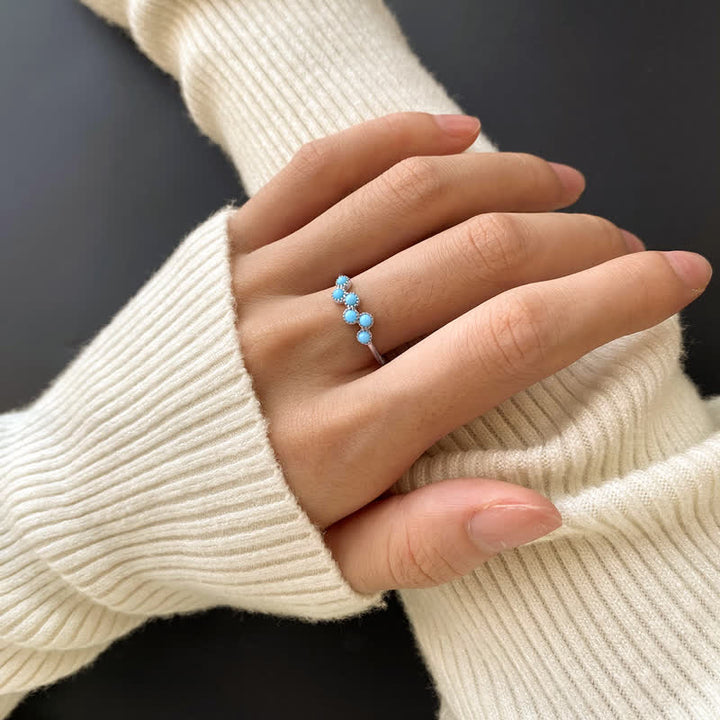 Anillo de pareja creativo de cuatro garras con turquesa redonda de Olivenorma