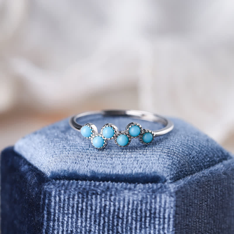 Anillo de pareja creativo de cuatro garras con turquesa redonda de Olivenorma