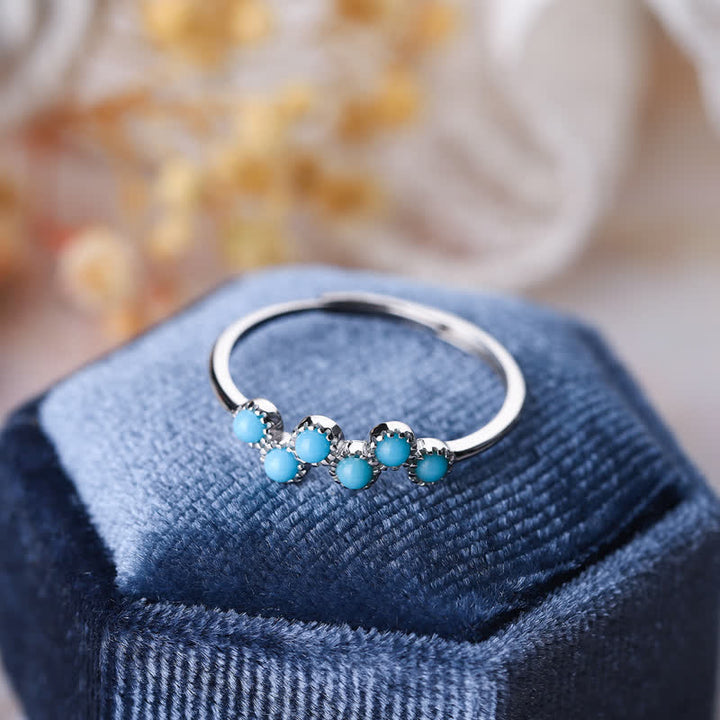 Anillo de pareja creativo de cuatro garras con turquesa redonda de Olivenorma