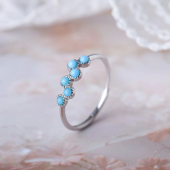 Anillo de pareja creativo de cuatro garras con turquesa redonda de Olivenorma