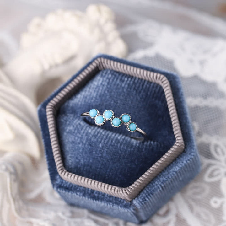Anillo de pareja creativo de cuatro garras con turquesa redonda de Olivenorma