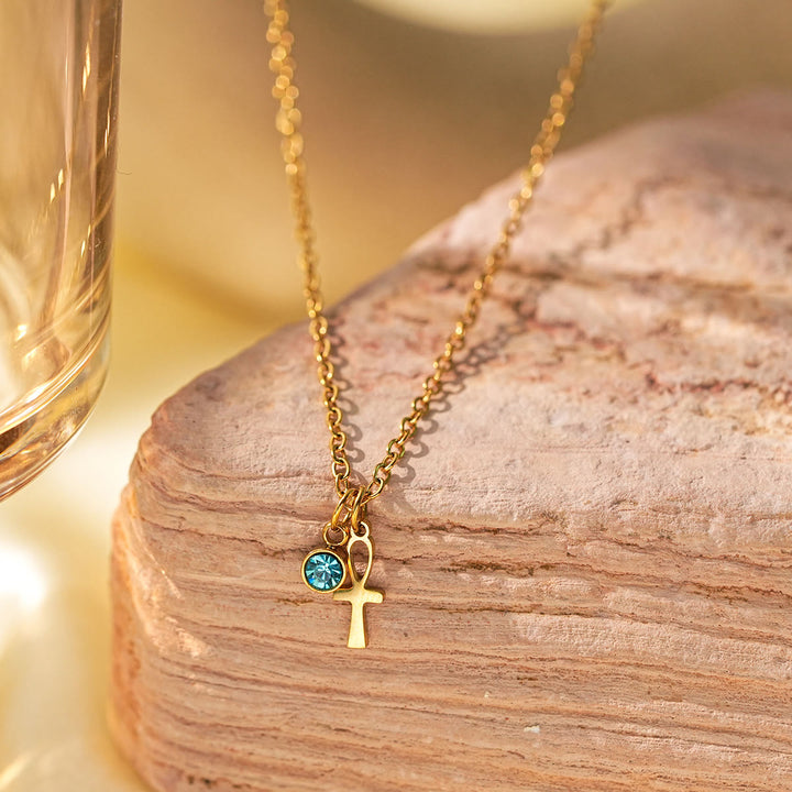 Collar con dije de cruz de aguamarina y símbolo de Hamsa con mal de ojo de Olivenorma