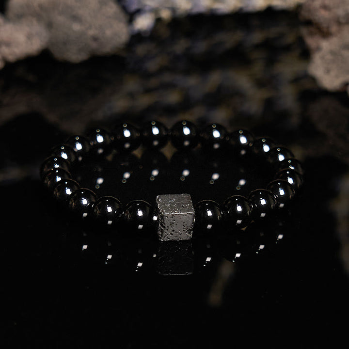 Pulsera de cuentas de obsidiana y piedra de lava tallada en cubos de Olivenorma