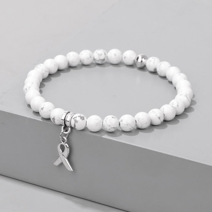 Pulsera de la suerte con cuentas de piedras preciosas naturales y dijes de cinta de Olivenorma
