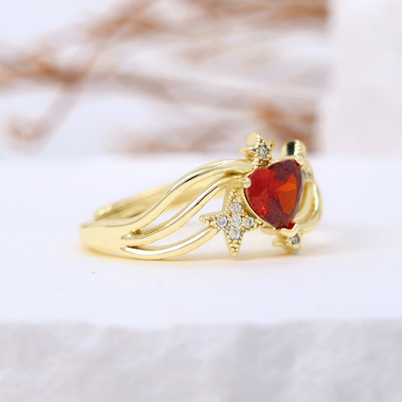 Anillo con forma de corazón y granate y estrella de circonita blanca de Olivenorma