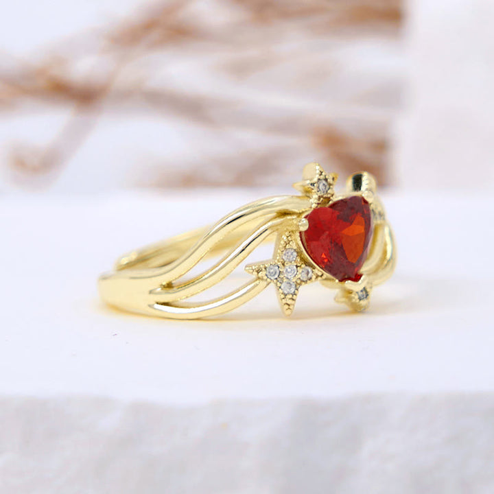 Anillo con forma de corazón y granate y estrella de circonita blanca de Olivenorma