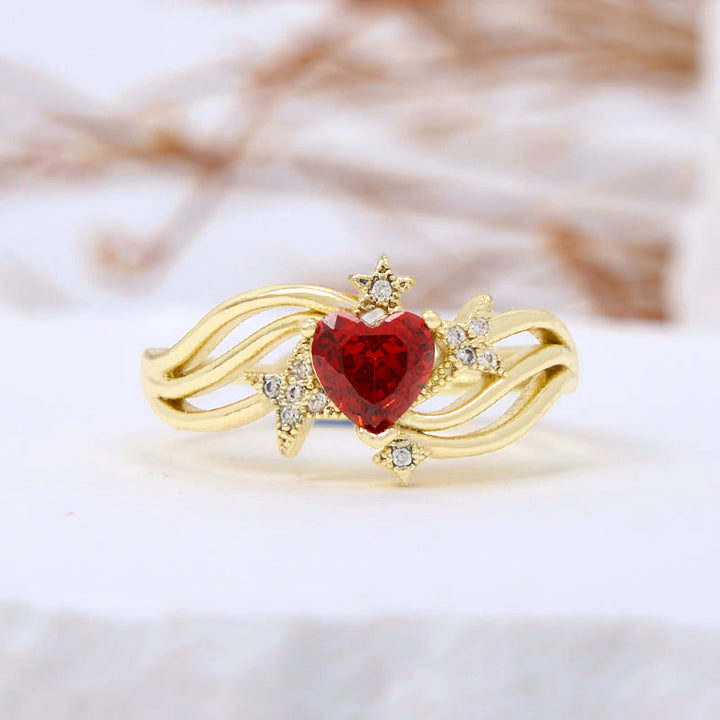 Anillo con forma de corazón y granate y estrella de circonita blanca de Olivenorma