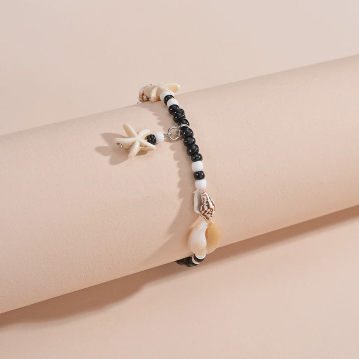 Tobillero con cuentas de caracol y estrella de mar de ónix negro y turquesa de Olivenorma