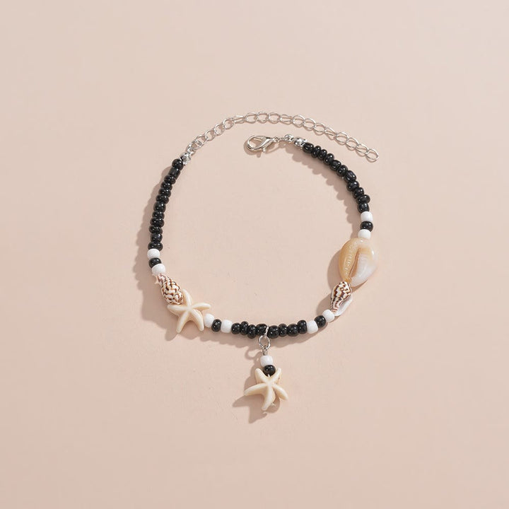 Tobillero con cuentas de caracol y estrella de mar de ónix negro y turquesa de Olivenorma