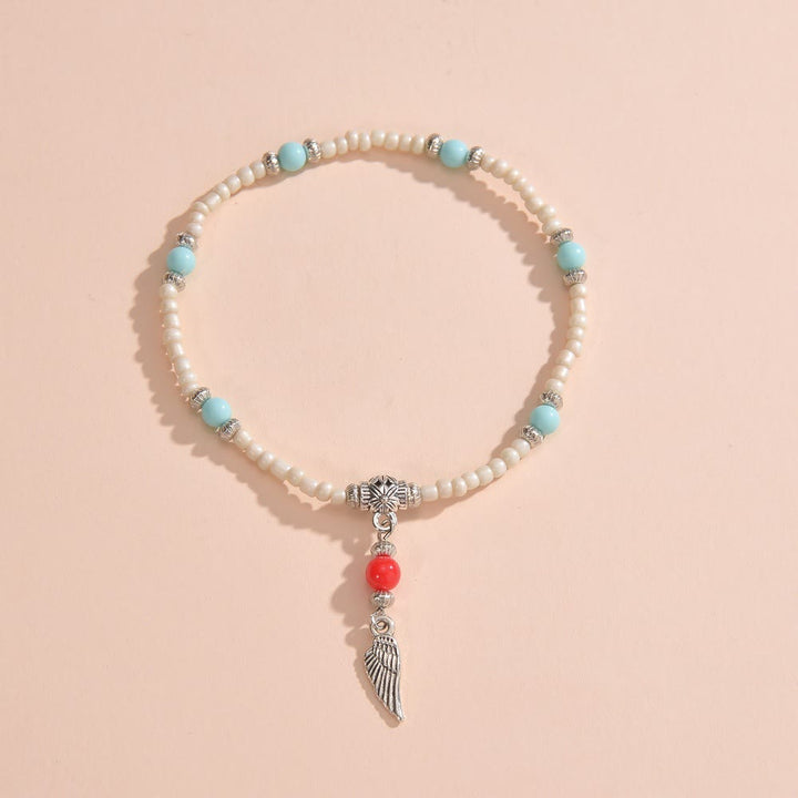 Tobillera con colgante de plumas de metal con cuentas de turquesa blanca de Olivenorma