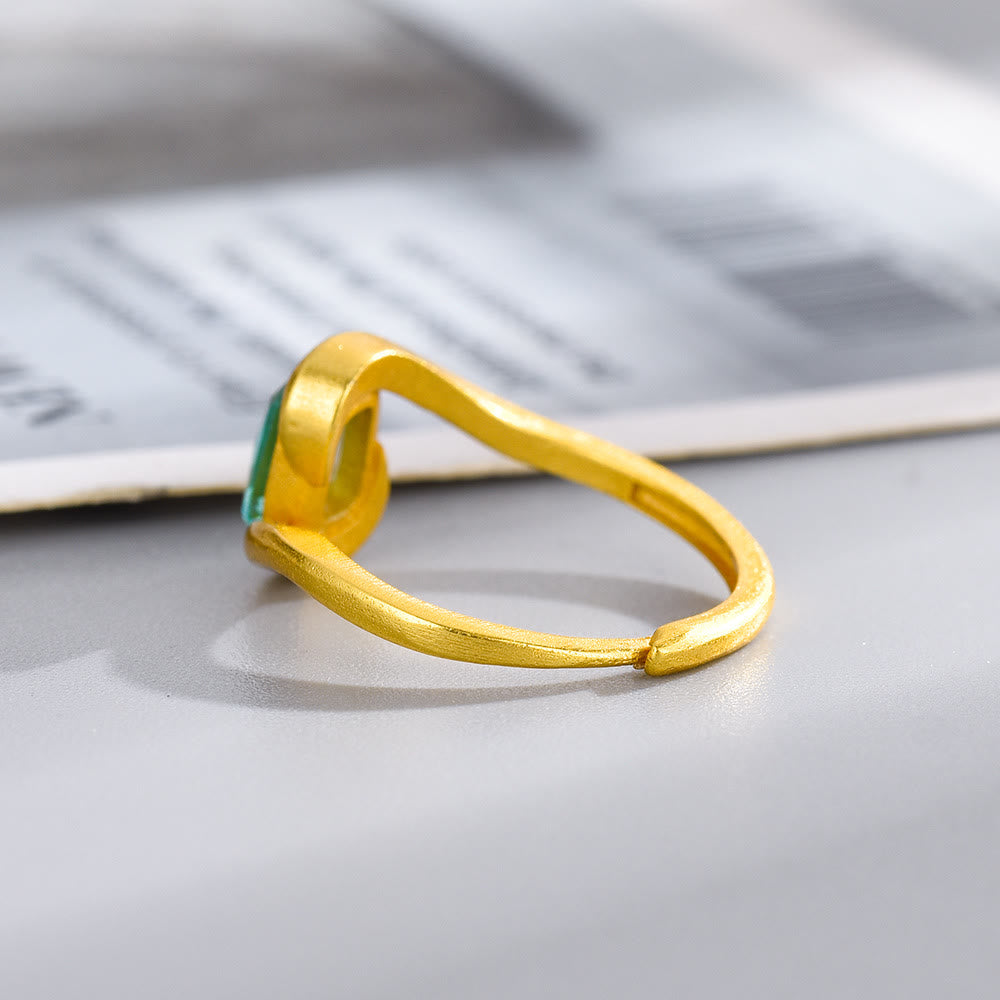Anillo con forma de ojo de ciclón y esmeralda de talla cuadrada de Olivenorma