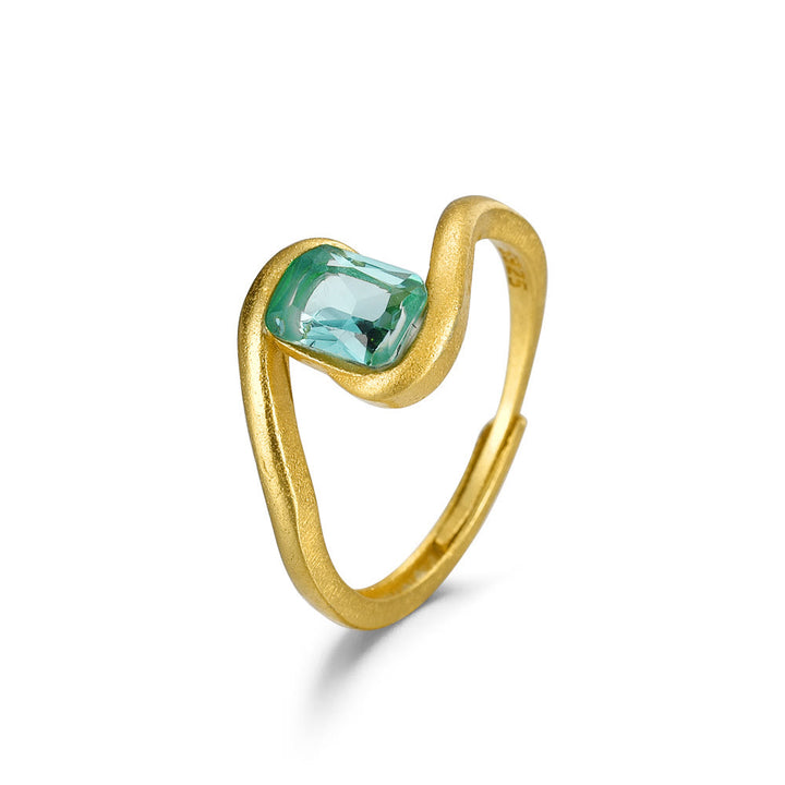 Anillo con forma de ojo de ciclón y esmeralda de talla cuadrada de Olivenorma