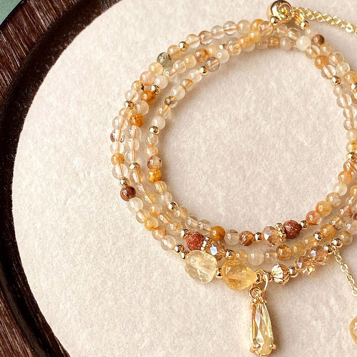 Pulsera y collar de cuentas de cuarzo rutilado en oro y citrino de Olivenorma
