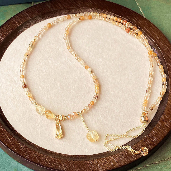 Pulsera y collar de cuentas de cuarzo rutilado en oro y citrino de Olivenorma