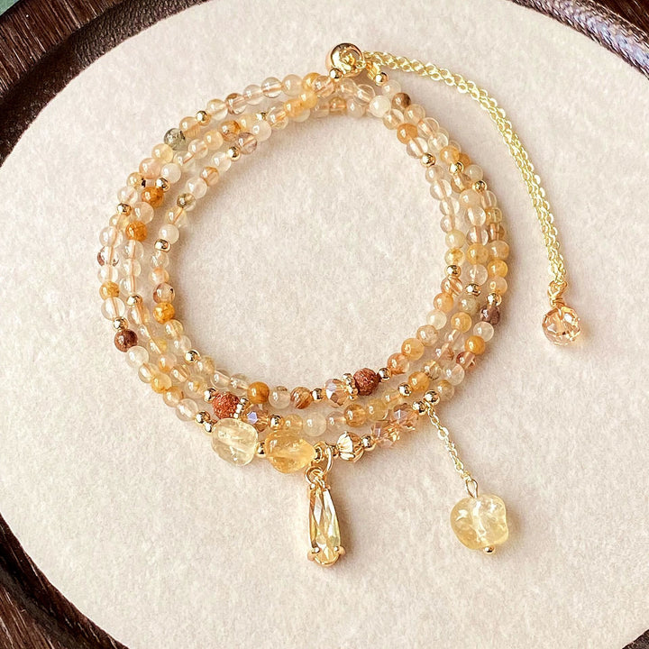 Pulsera y collar de cuentas de cuarzo rutilado en oro y citrino de Olivenorma