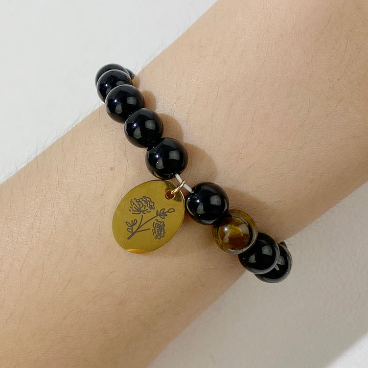Pulsera Olivenorma de metal con cuentas de obsidiana de 8 mm y flor de nacimiento