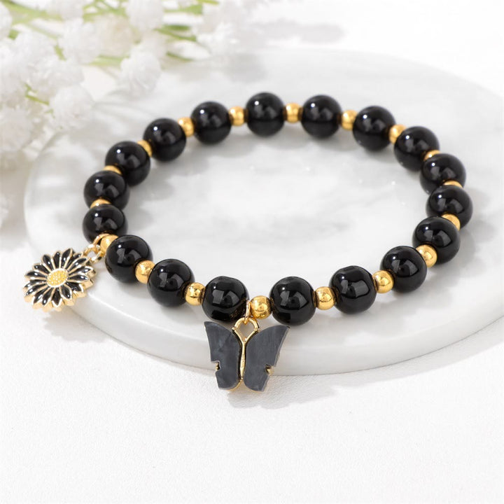 Pulsera con colgante de mariposa y cuentas de cristal natural de Olivenorma