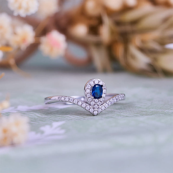 Anillo Olivenorma con corona en forma de lágrima y topacio azul