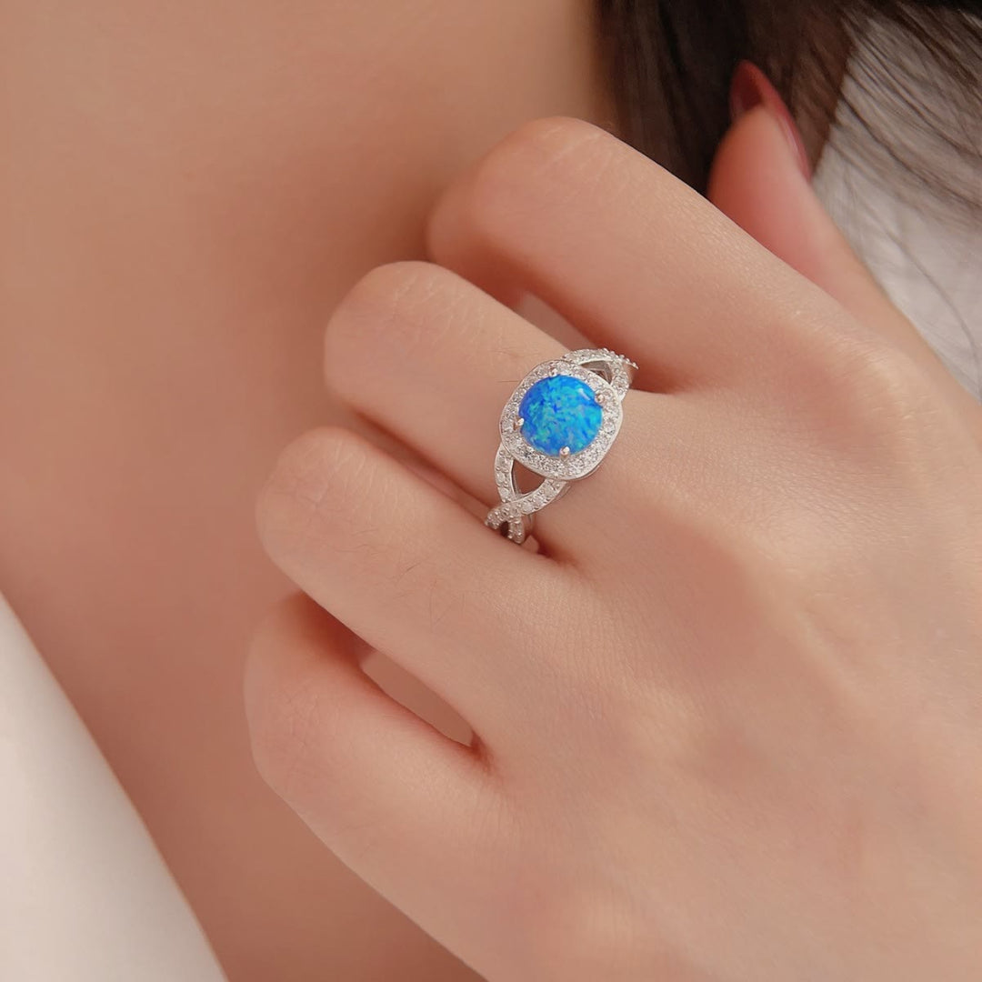 Anillo de plata de ley 925 con circonita blanca y ópalo azul de Olivenorma