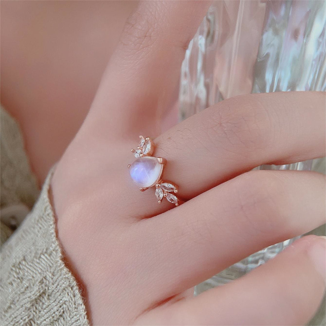Anillo de oro rosa con forma de gota de circonita blanca y piedra lunar de Olivenorma. 