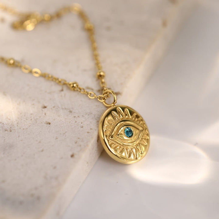 Collar de acero de titanio 316L con ojo malvado y topacio azul de Olivenorma