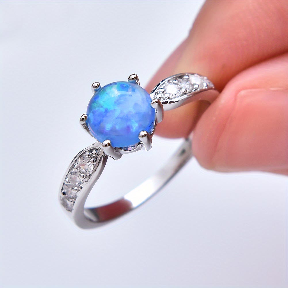Anillo de banda con borde de ópalo redondo y seis garras de Olivenorma
