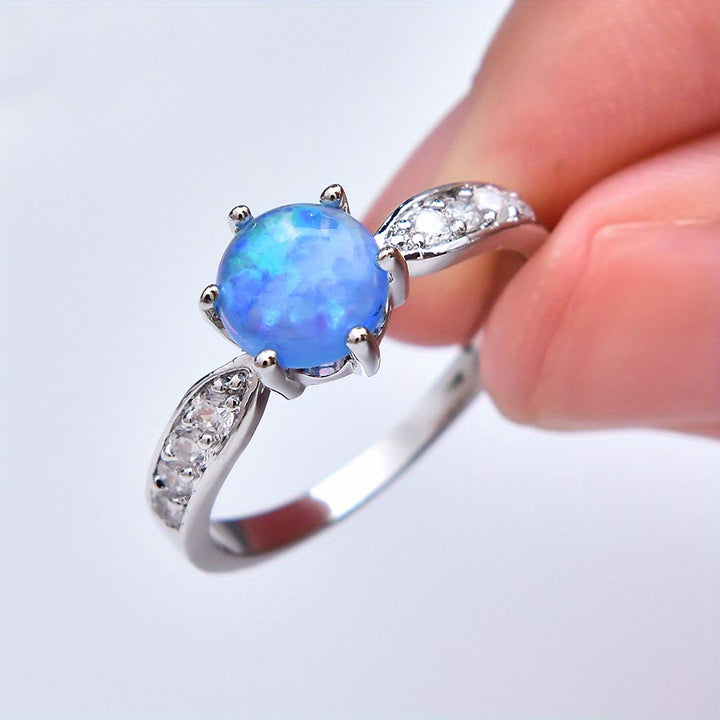 Anillo de banda con borde de ópalo redondo y seis garras de Olivenorma