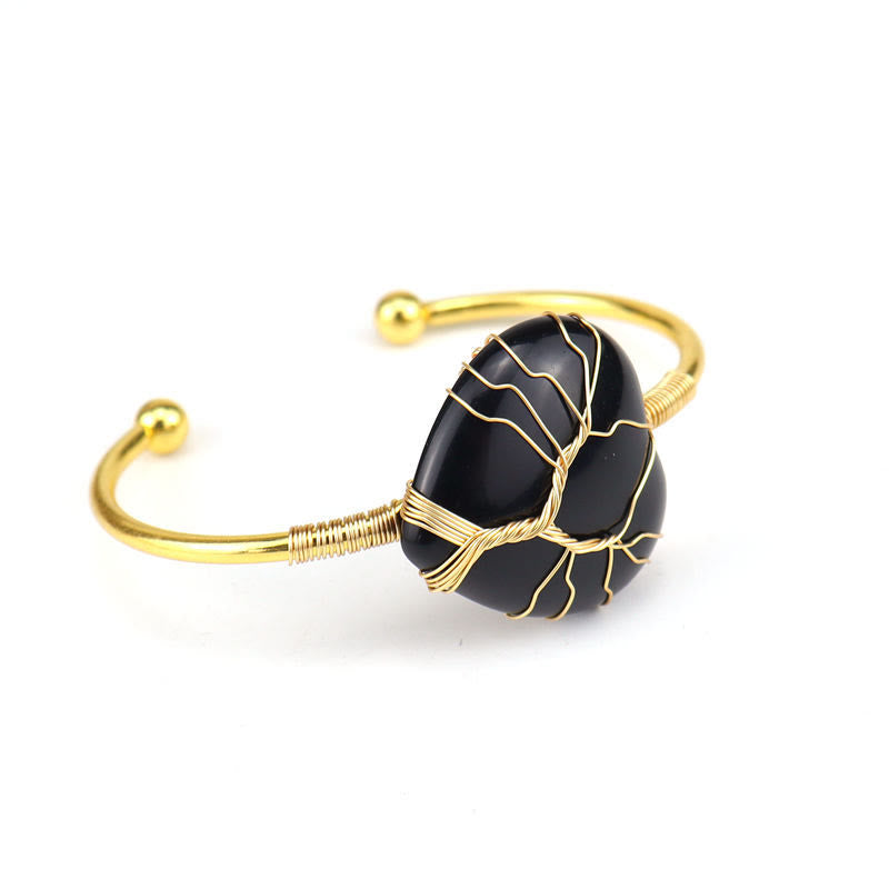Pulsera de cristal natural en forma de corazón envuelta en alambre de cobre y oro de Olivenorma.
