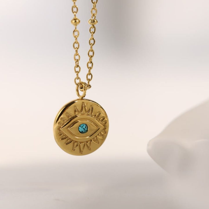 Collar de acero de titanio 316L con ojo malvado y topacio azul de Olivenorma