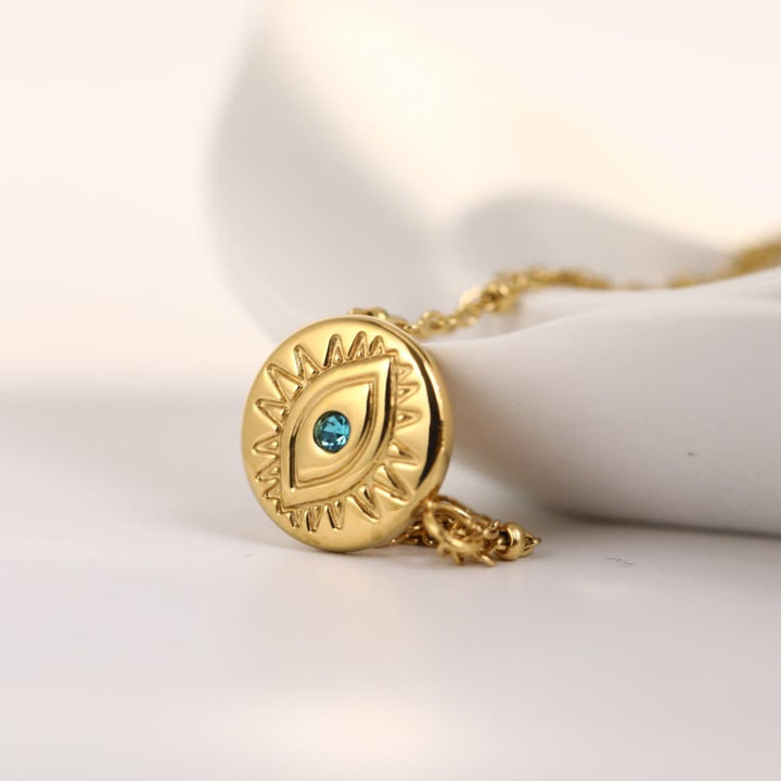 Collar de acero de titanio 316L con ojo malvado y topacio azul de Olivenorma