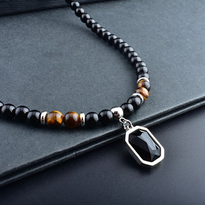 Collar de acero y titanio con cuentas de obsidiana y ojo de tigre para hombre de Olivenorma