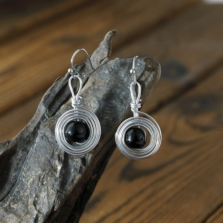Aros con diseño de obsidiana y metal punk con envoltura de alambre de Olivenorma