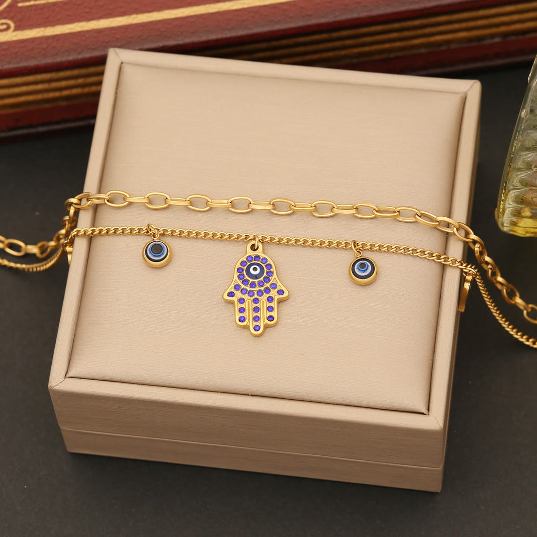 Conjunto de collar, pulsera y pendientes de resina epoxi con ojo de hamsa y mal de ojo de Olivenorma
