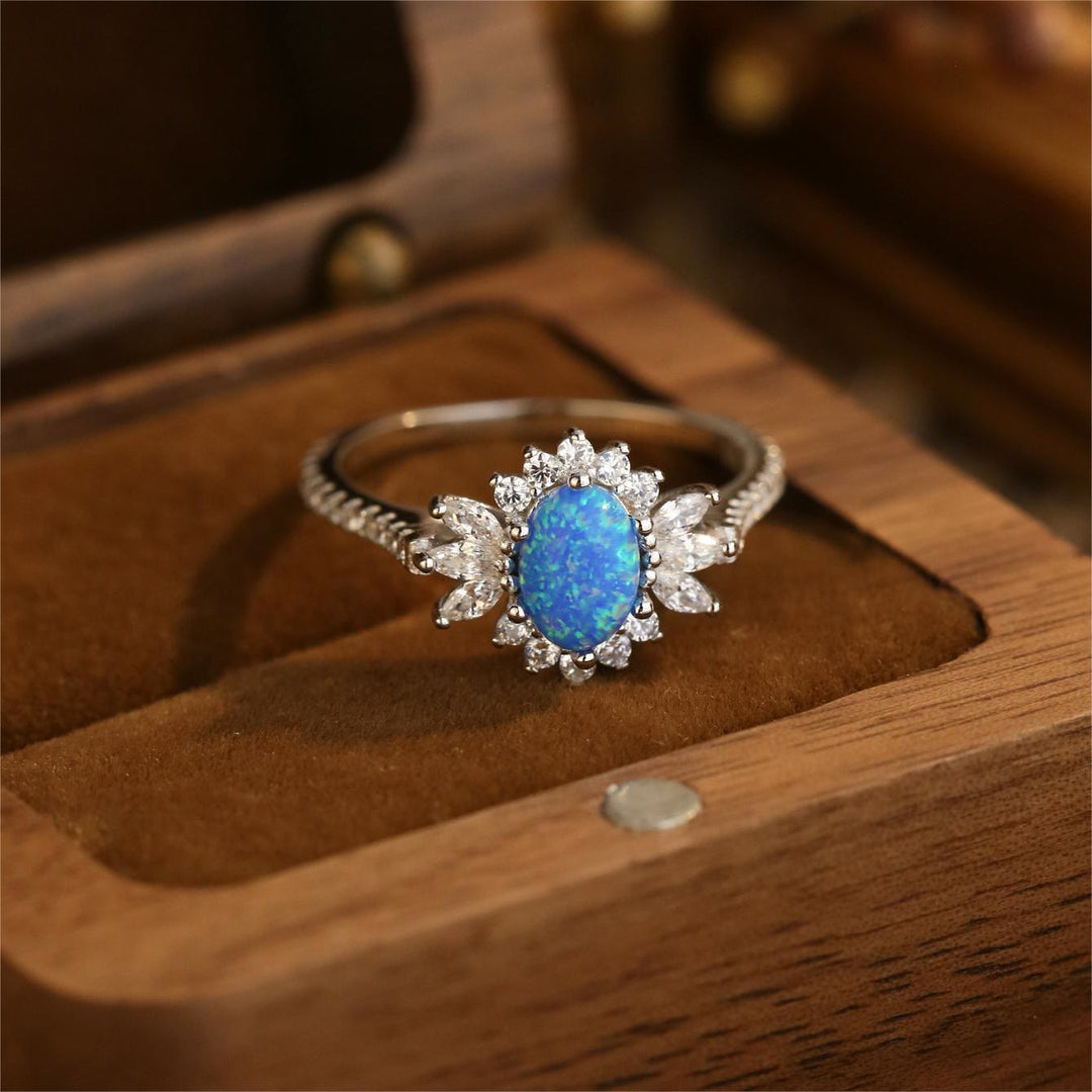 Anillo de plata 925 con diseño de girasol y ópalo azul blanco de Olivenorma 