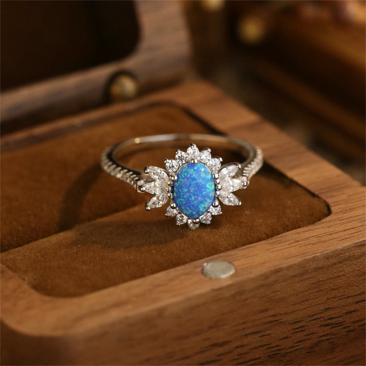 Anillo de plata 925 con diseño de girasol y ópalo azul blanco de Olivenorma 