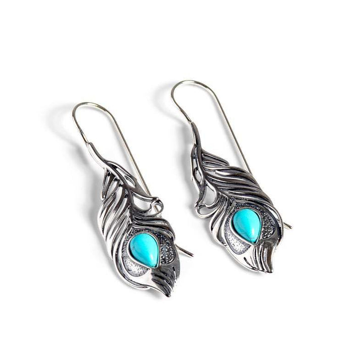 Pendientes bohemios con plumas de pavo real turquesas recortadas de Olivenorma