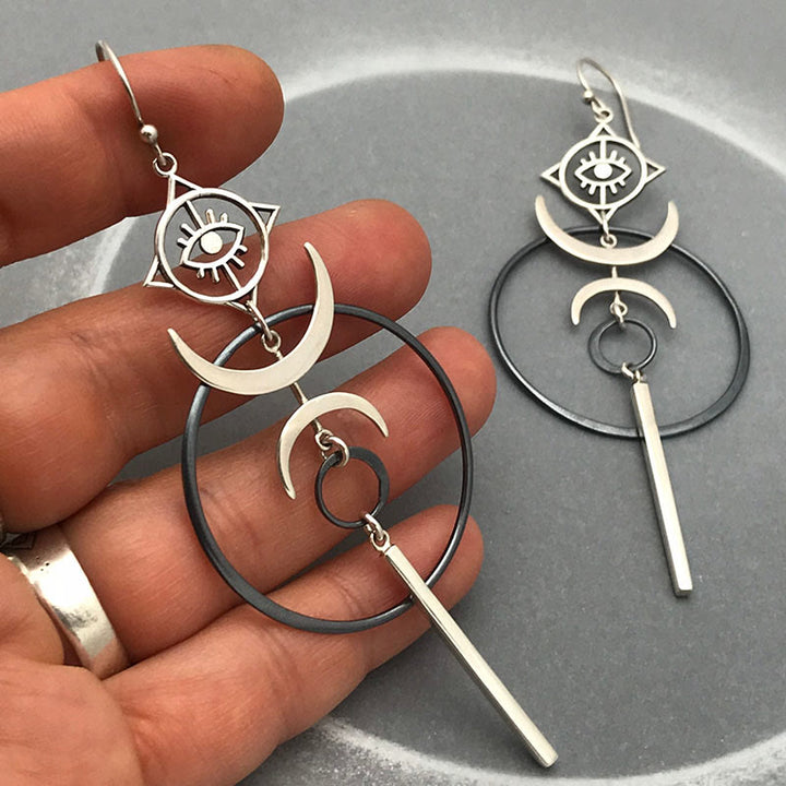 Pendientes largos con forma de media luna y forma de ojo de bruja con diseño geométrico de Olivenorma